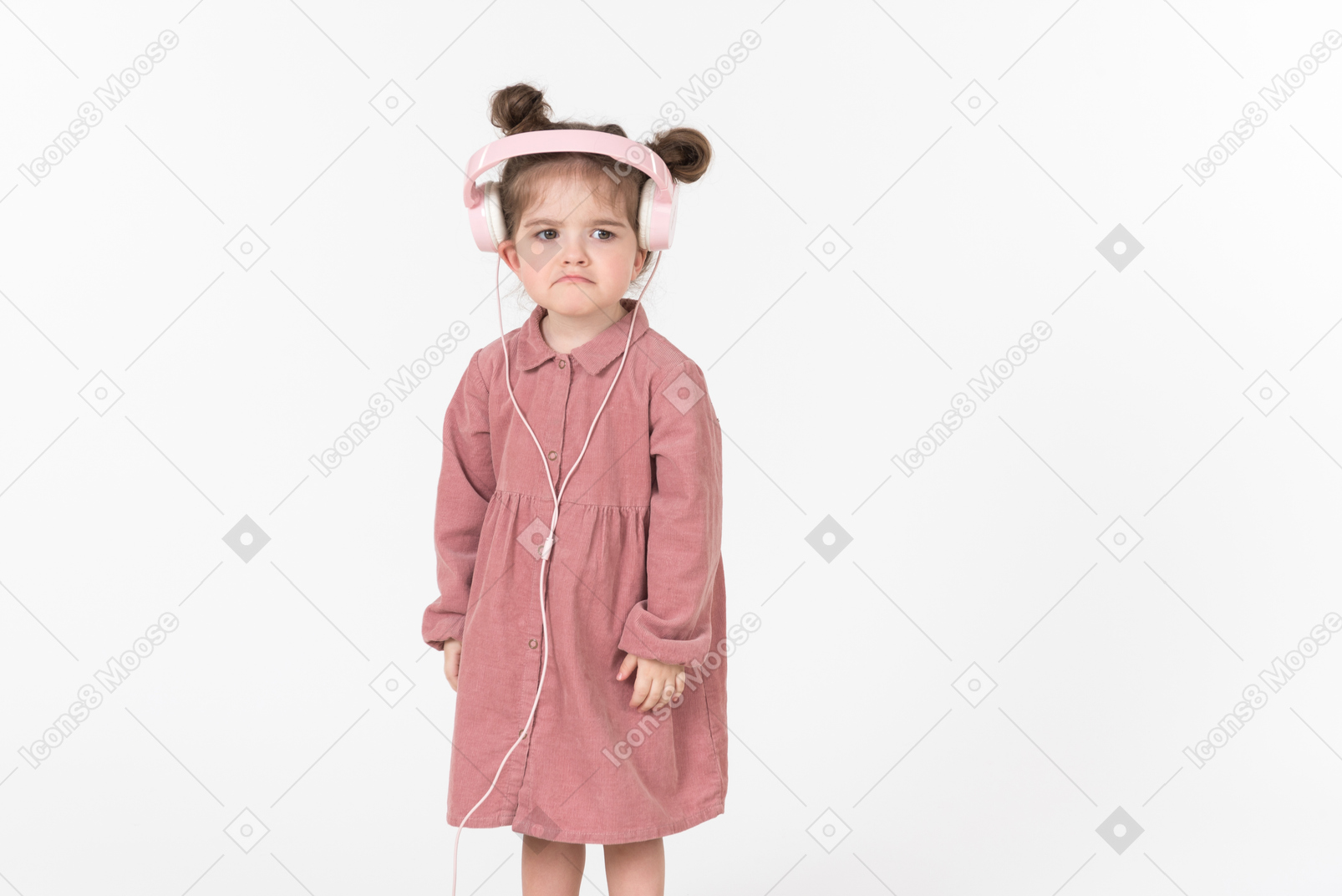 Kid girl in pink dress wearing pink headphones
