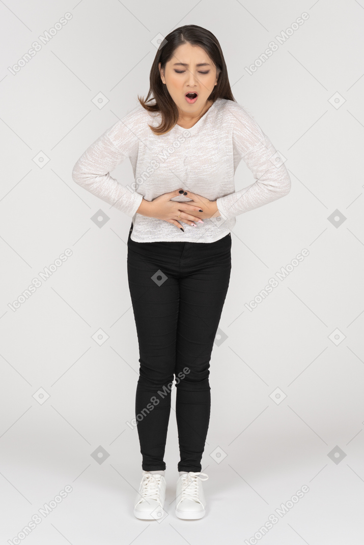 Young brunette woman suffering from stomach pain
