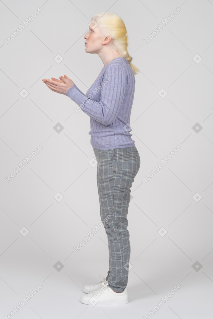 Side view of a young woman arguing and gesturing with hands