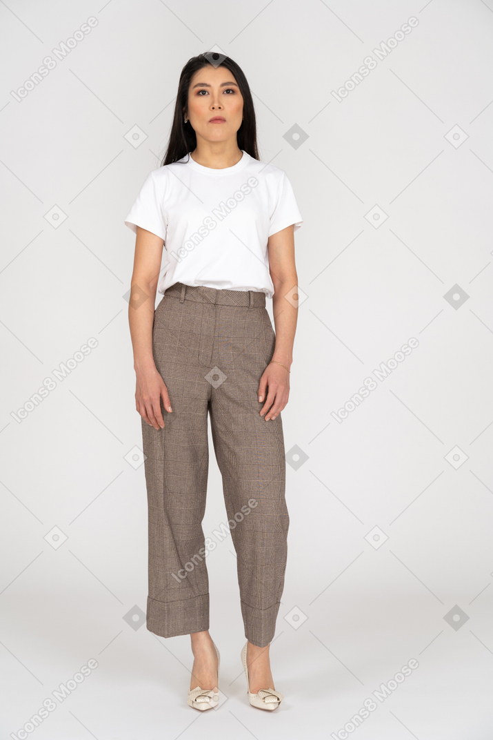 Front view of a young woman in breeches standing still