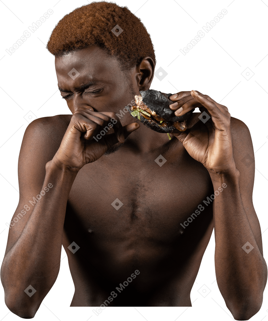 ハンバーガーを食べる若いアフロ男の正面図