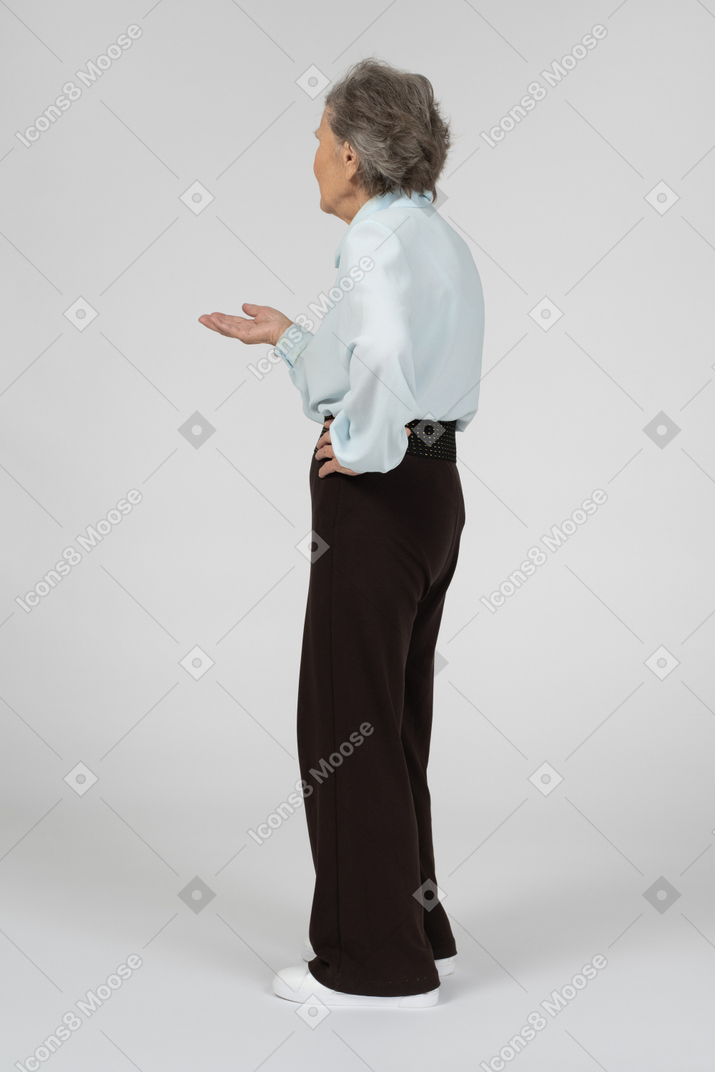 Three-quarter back view of a confused old woman