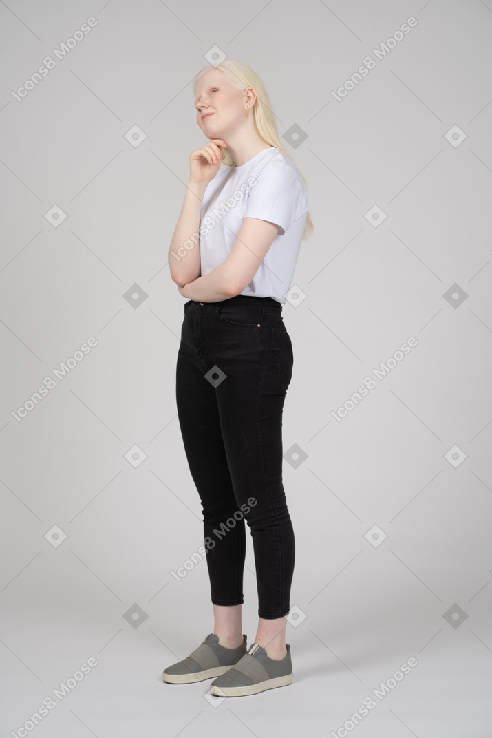 Pensive woman in casual clothes touching her chin