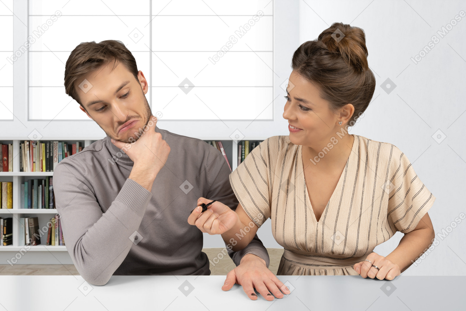 Woman painting nails on a man's hand in a room
