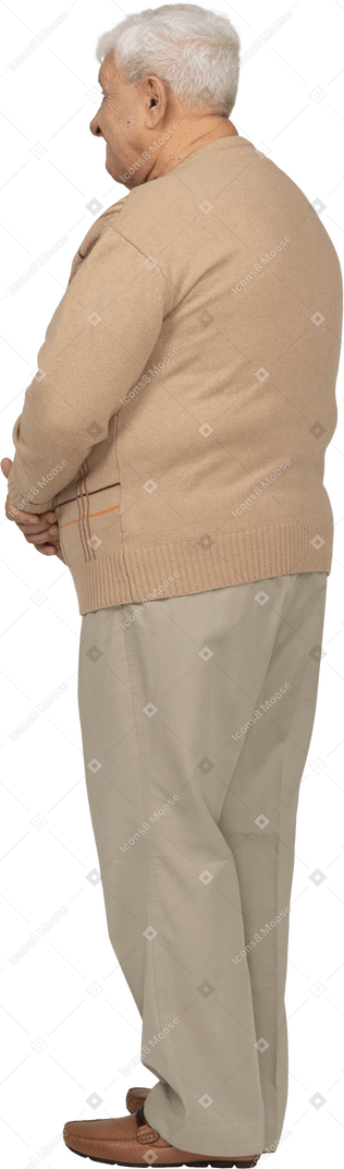 Side view of an old man in casual clothes making faces