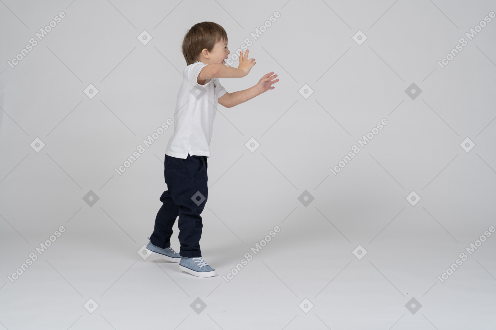 A boy standing in front of an empty wall