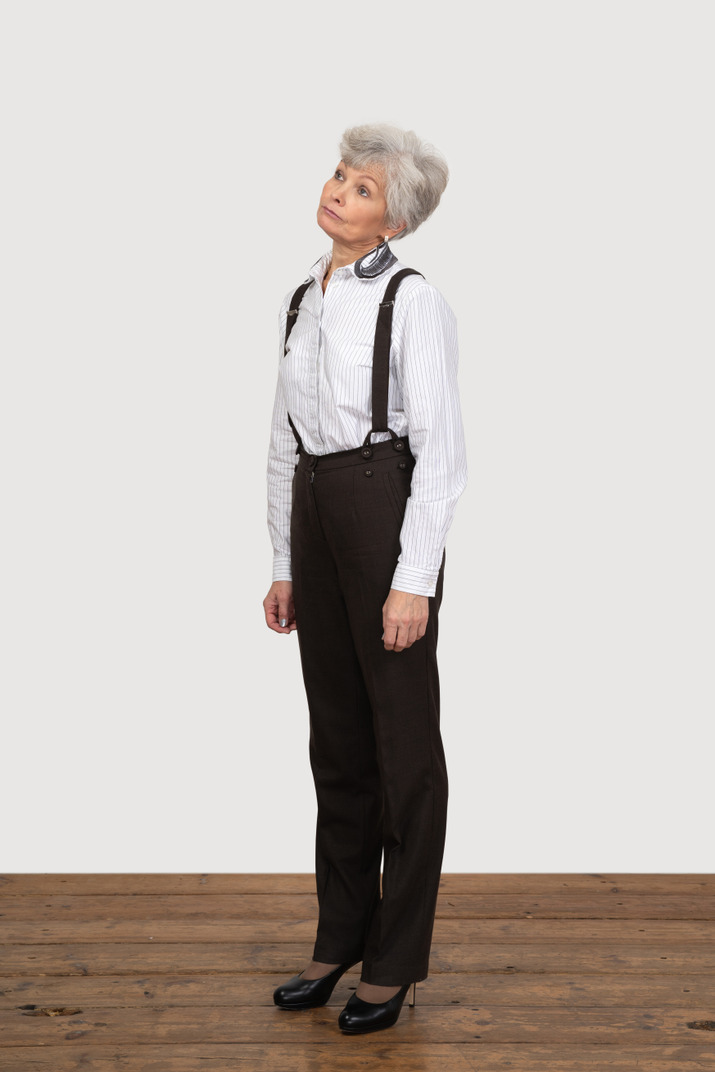 Three-quarter view of a careless old lady in office clothing