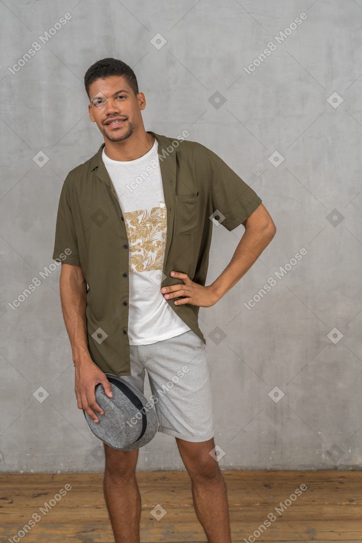 Cheerful man in casual clothes holding hand on hip