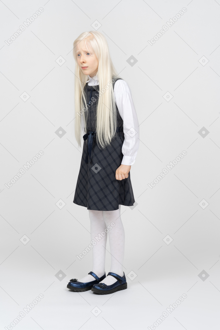 Schoolgirl looking very upset and clenching her fist