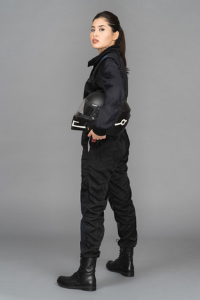 A young biker posing with a helmet