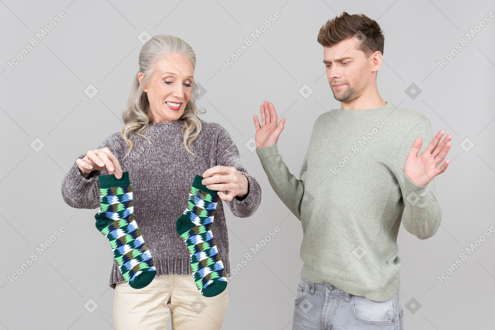 Elegant old woman holding men's socks and a young guy looking bewildered