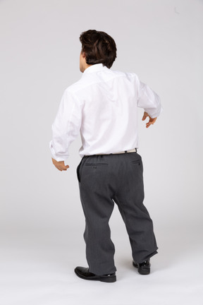Back view of young man leaning on one leg
