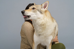 Close-up of a dog held by her female master