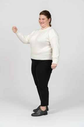 Plus size woman in white shirt posing