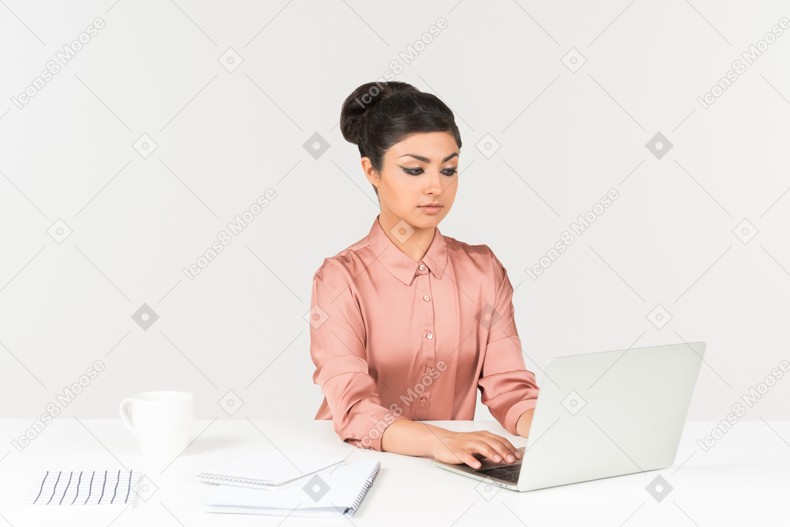 Young indian office employee working on laptop