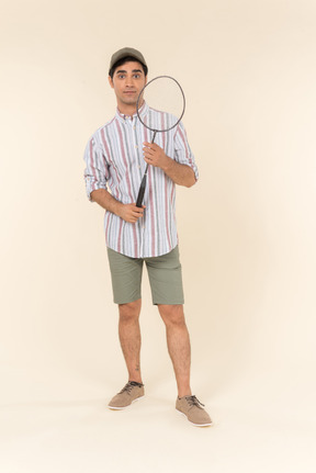 Young caucasian man holding tennis racket