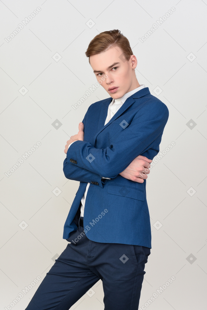 Handsome young man standing with his hands crossed
