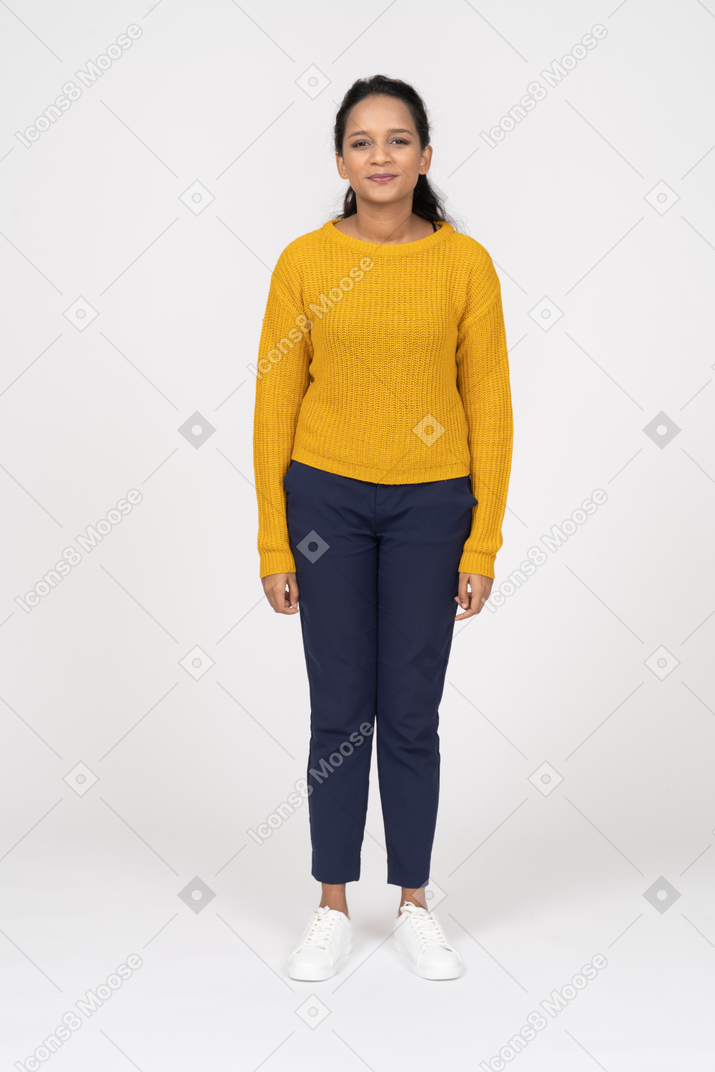 Front view of a happy woman in casual clothes looking at camera