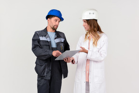 Female and male engineer colleagues discussing some work stuff