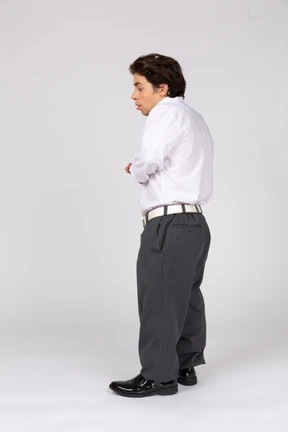 Side view of young man in formal wear looking down