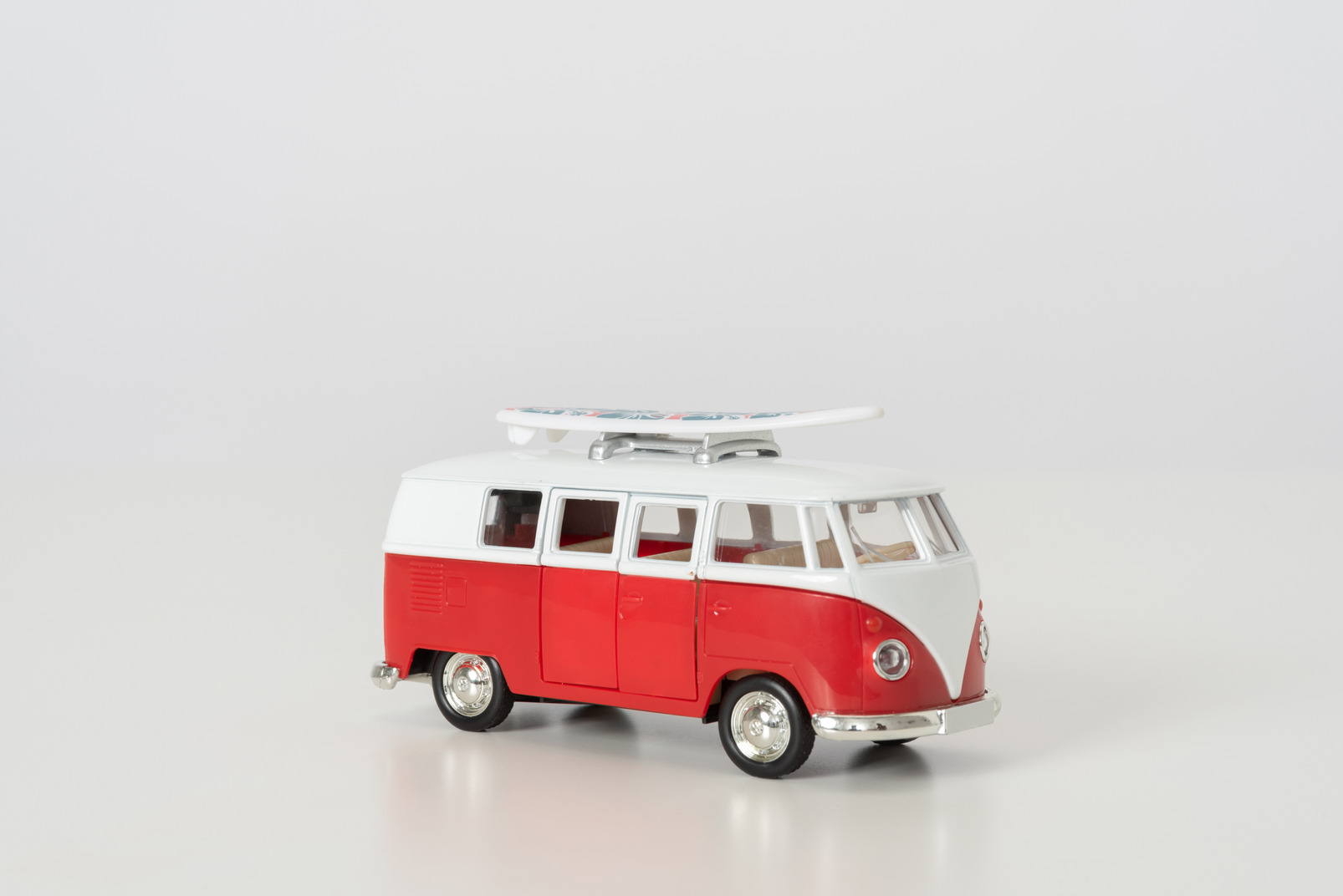 Hippie toy autobus photographed sideways on grey background