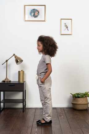 Good looking girl kid posing on the apartment background