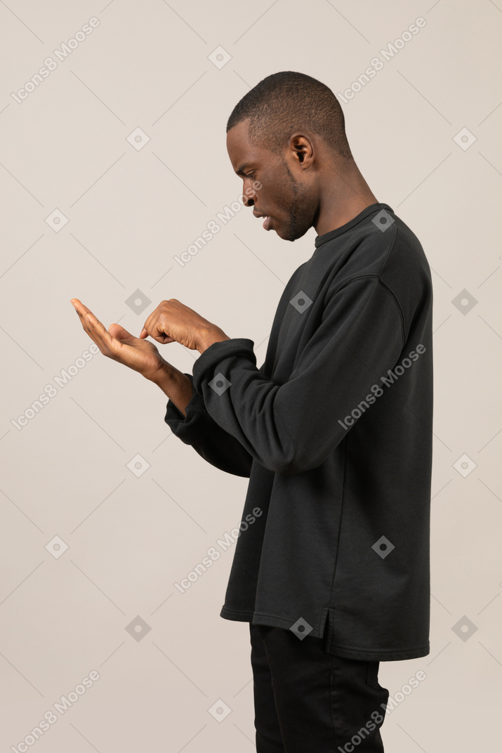 Side view of man using imaginary smartphone