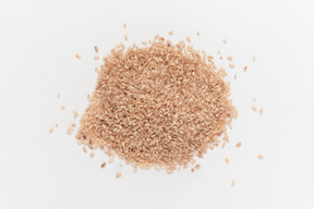 Pile of brown grains on white background