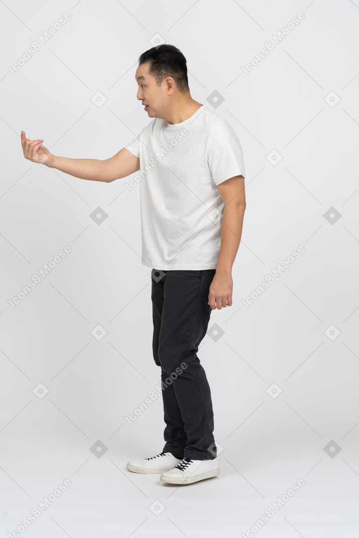 Side view of an angry man asking someone to come closer