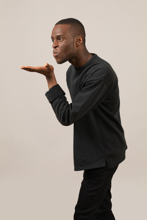 Young man blowing a kiss