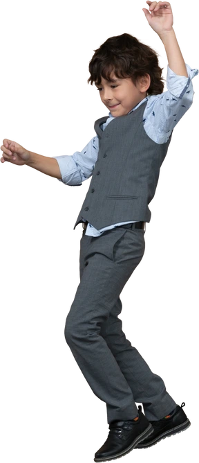 Side view of a boy in suit dancing