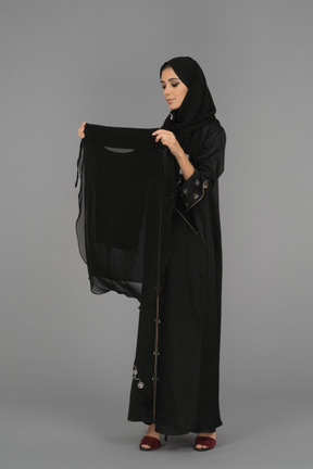 Young arab woman is about to wear a niqab