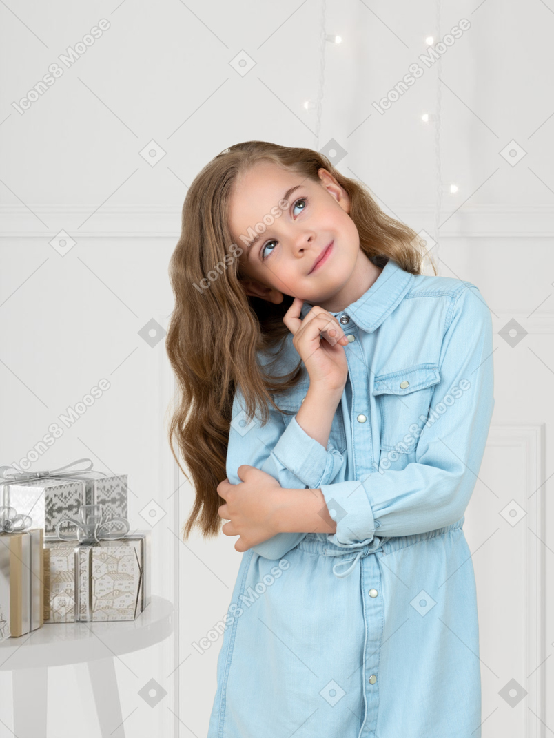 Little girl dreaming about christmas gifts