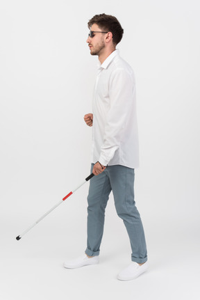 Blind man using a white cane