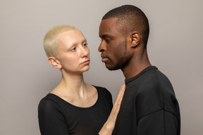 Young woman put her hand on man's chest