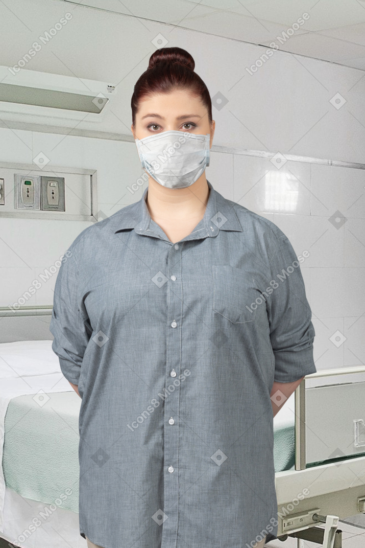 Woman wearing face mask standing in the hospital room
