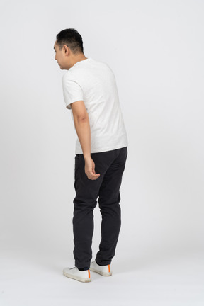 Rear view of a man in casual clothes eavsdropping