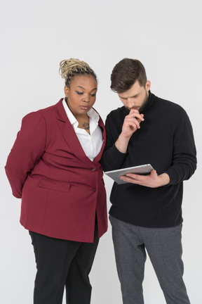 Colleagues looking attentively on a tablet