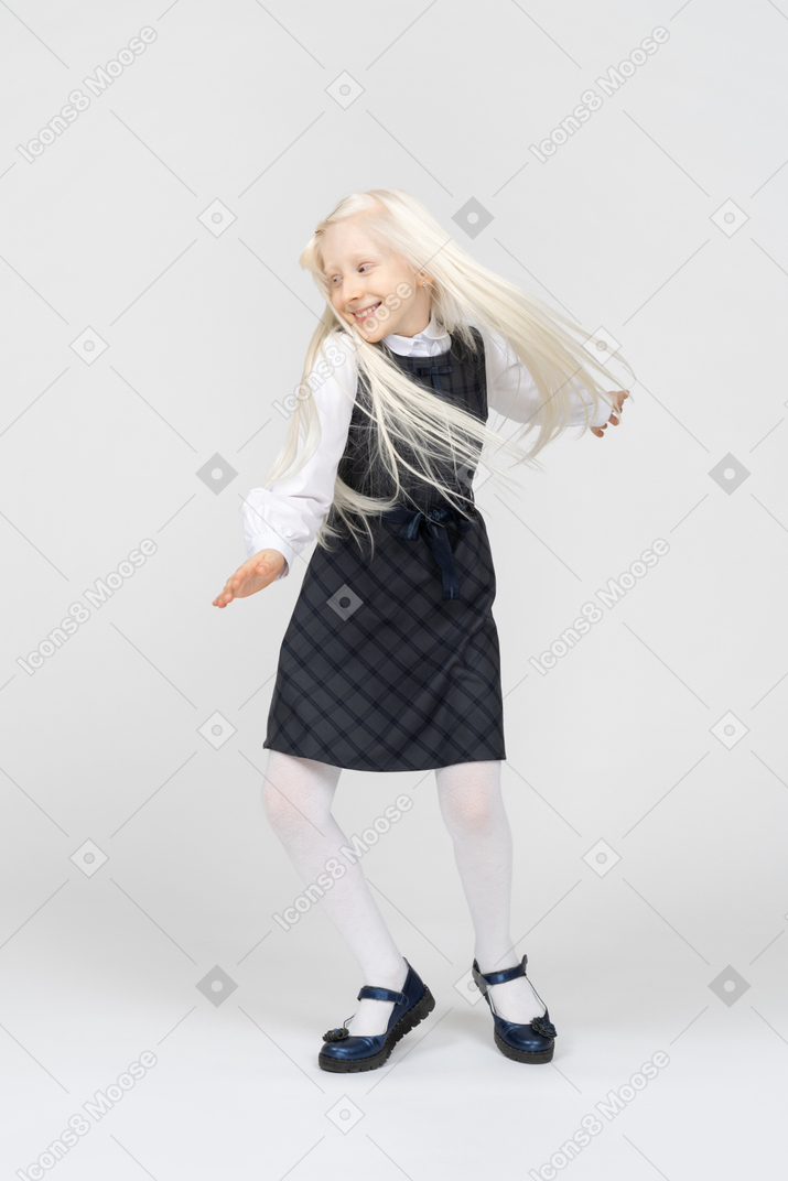 Schoolgirl smiling while spinning around
