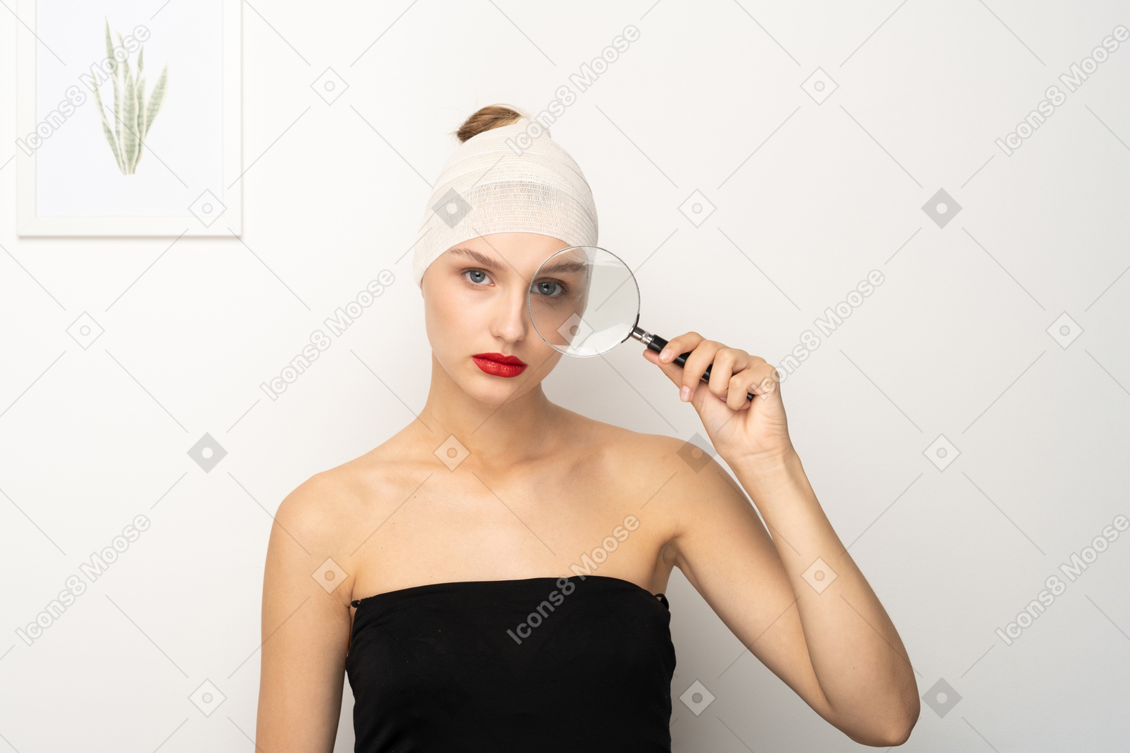 Young woman looking through magnifying glass