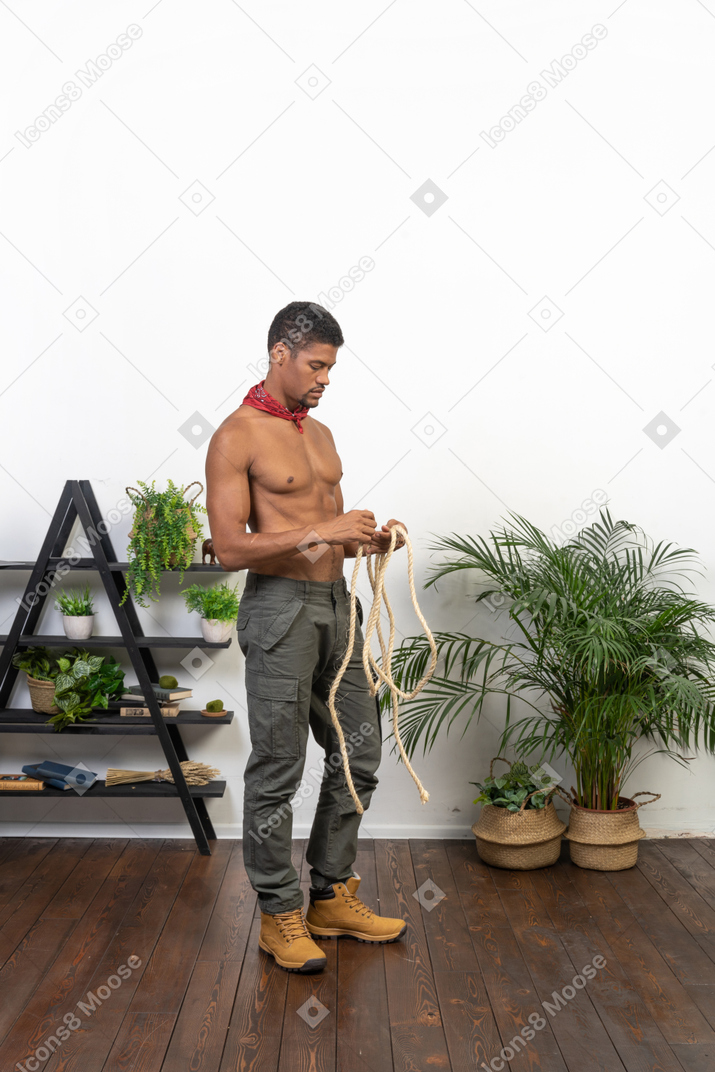 Good looking athletic man with the rope