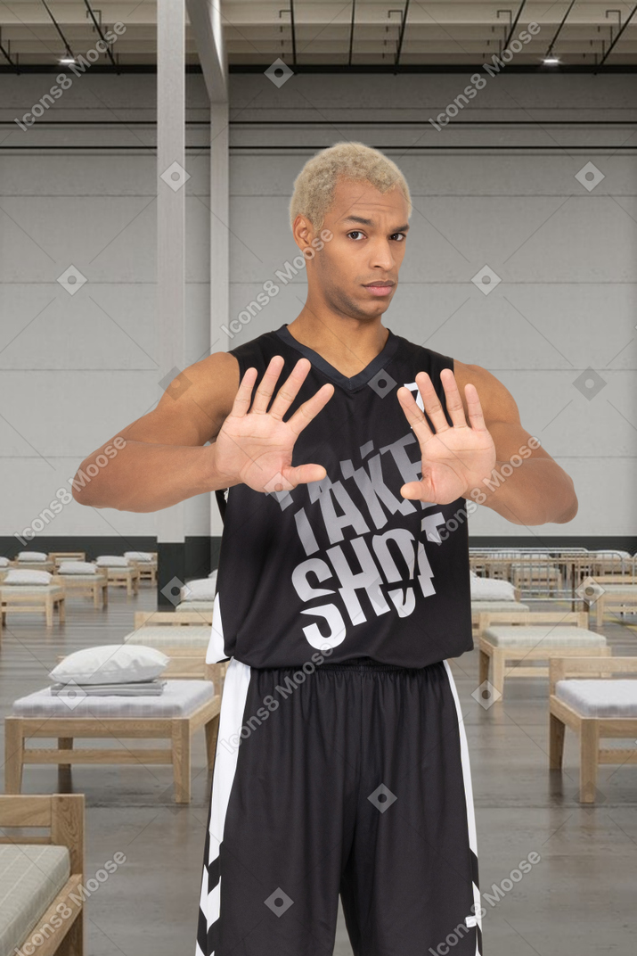 Man in a basketball outfit standing on a hospital background