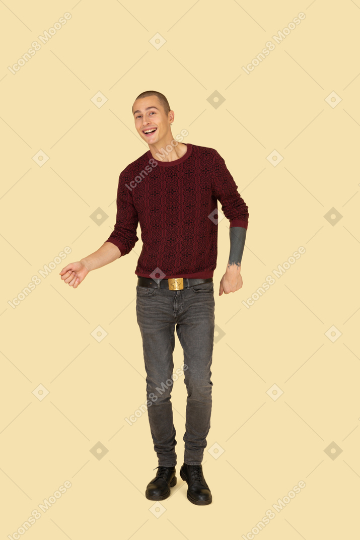 Front view of a dancing young man dressed in red pullover
