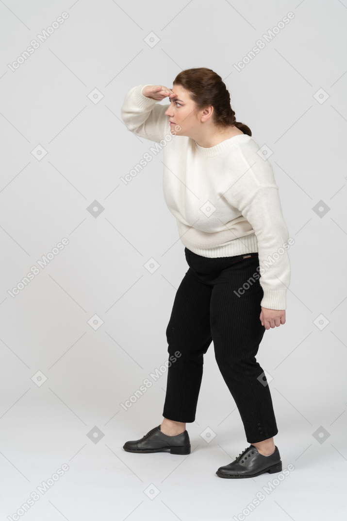 Side view of plus size woman in casual clothes looking for someone