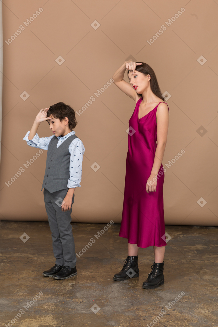 Boy and woman widening their eyes