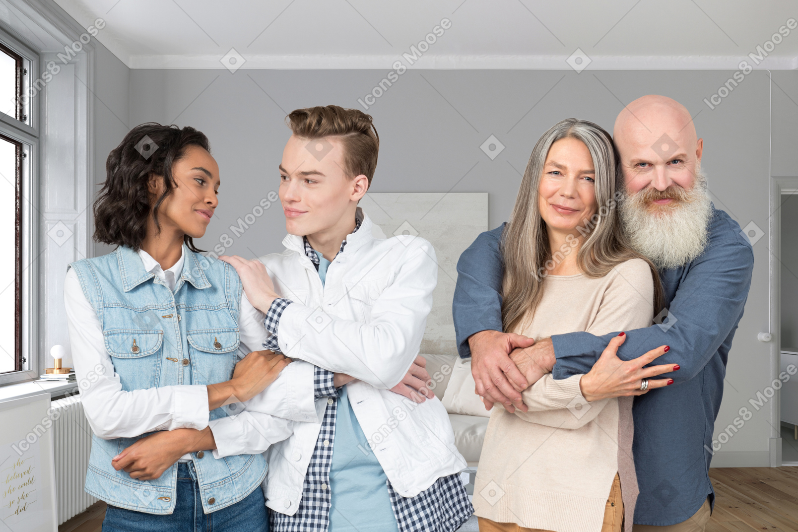 An old couple posing next to a young couple