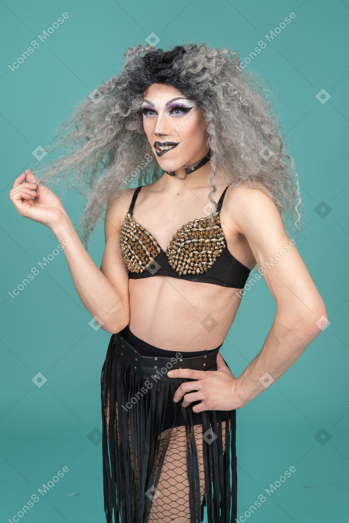 Drag queen standing with hand on hip and biting lip