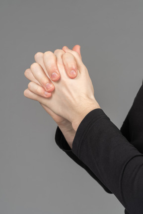 Side view of hands folded as a lock