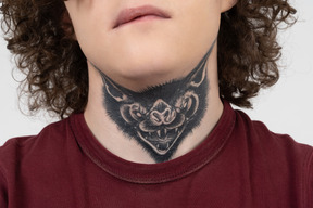 Brunet teenager with tattoo of a predator on the neck