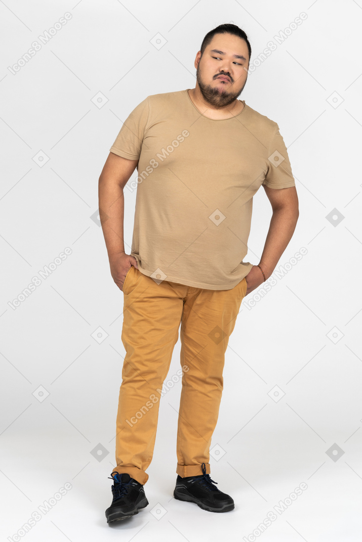Confident asian man standing against camera